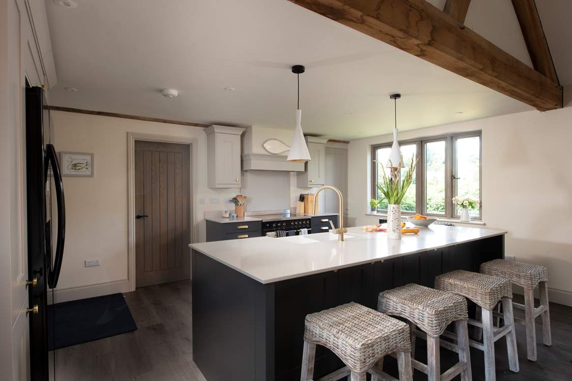 A striking combination of matte black and soft grey cabinetry.