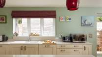 Gorgeous kitchen with views over the garden. Adjacent utility-room. 