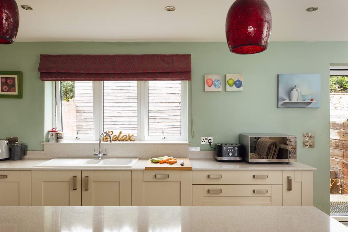 Gorgeous kitchen with views over the garden. Adjacent utility-room.
