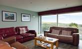 The stunning sea and rural views are drawn in through the large glass sliding doors in the first floor living-room.  - Thumbnail Image