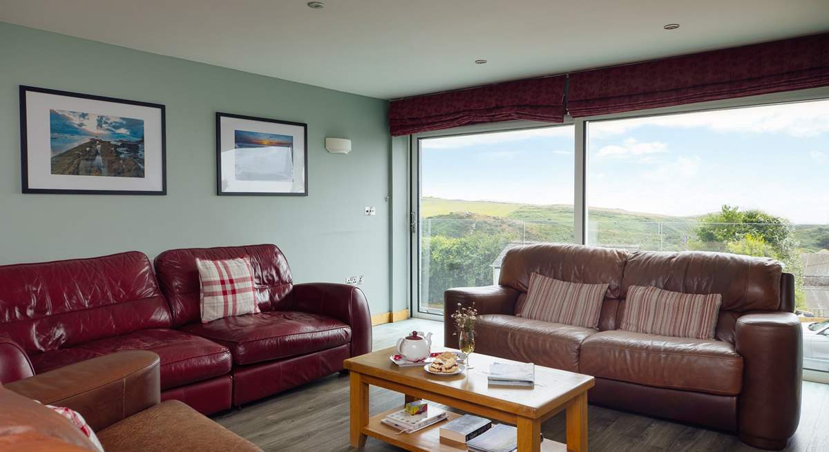 The stunning sea and rural views are drawn in through the large glass sliding doors in the first floor living-room. 