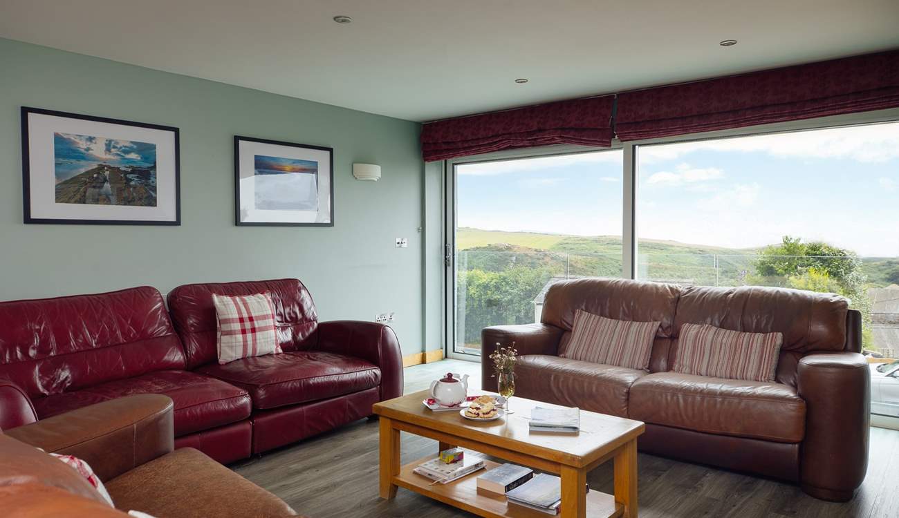 The stunning sea and rural views are drawn in through the large glass sliding doors in the first floor living-room. 