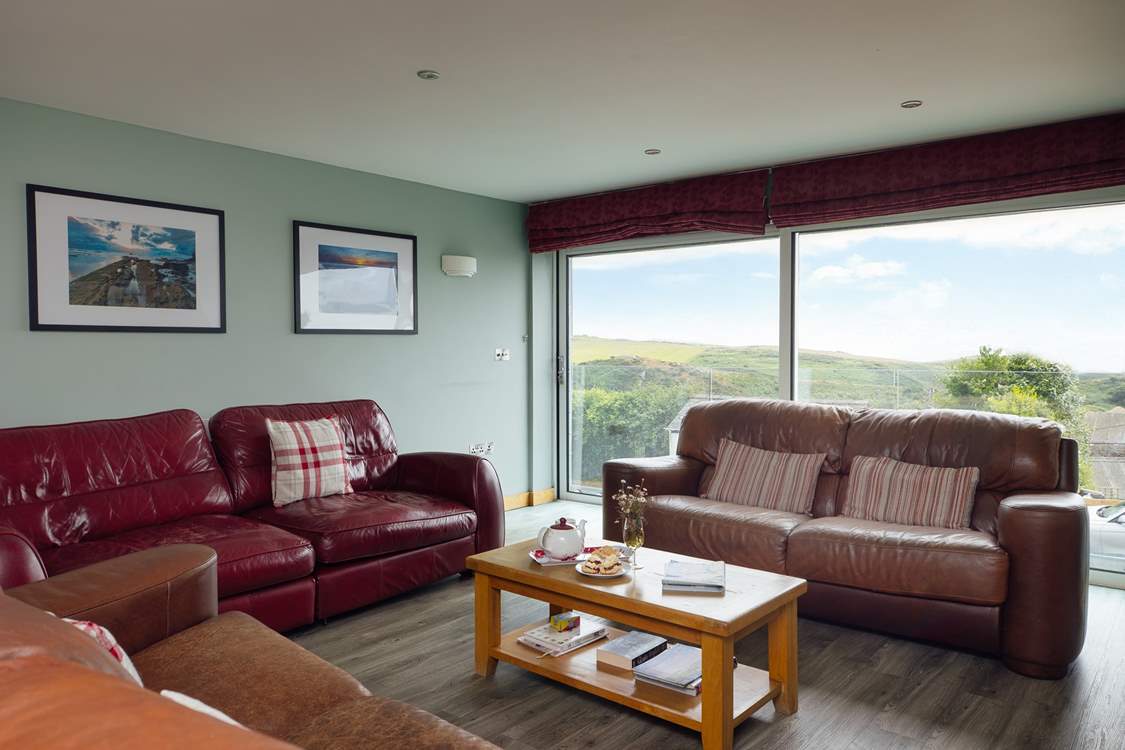 The stunning sea and rural views are drawn in through the large glass sliding doors in the first floor living-room.