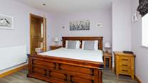 With a view to the front, the gorgeous super-king en suite on the ground floor. 