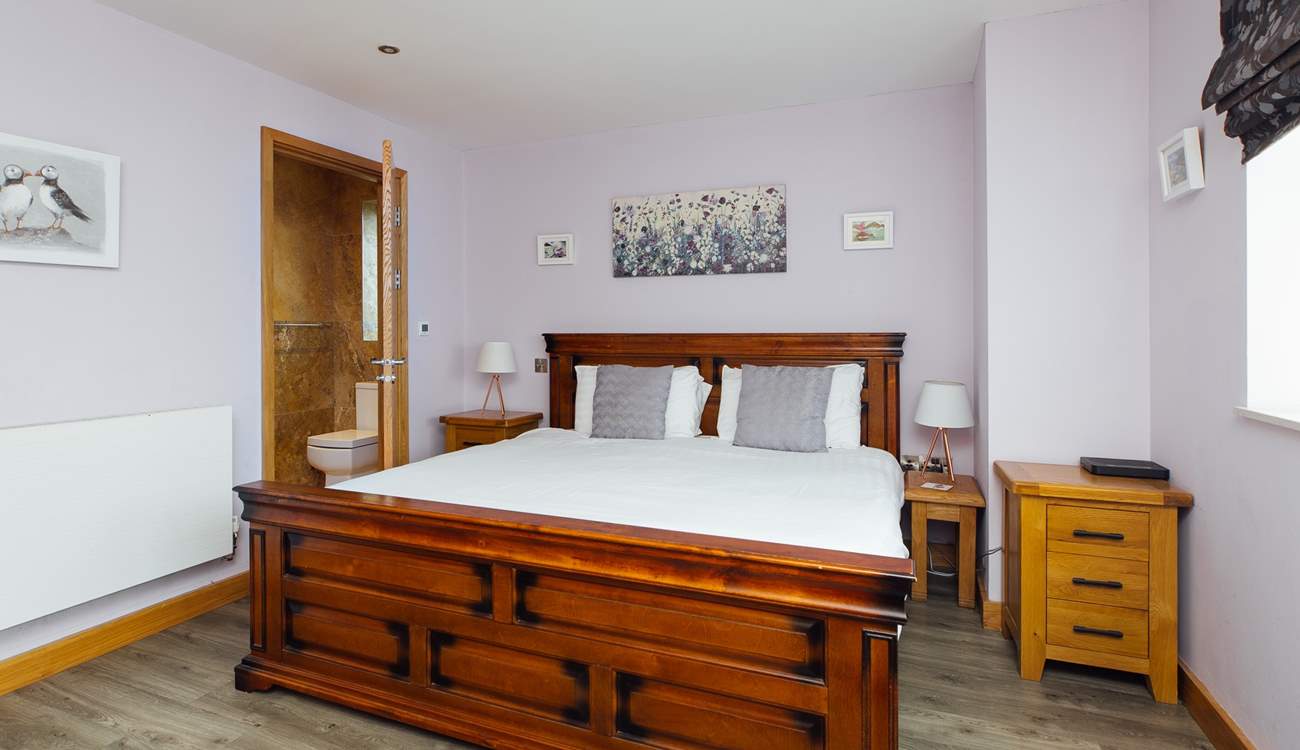 With a view to the front, the gorgeous super-king en suite on the ground floor. 