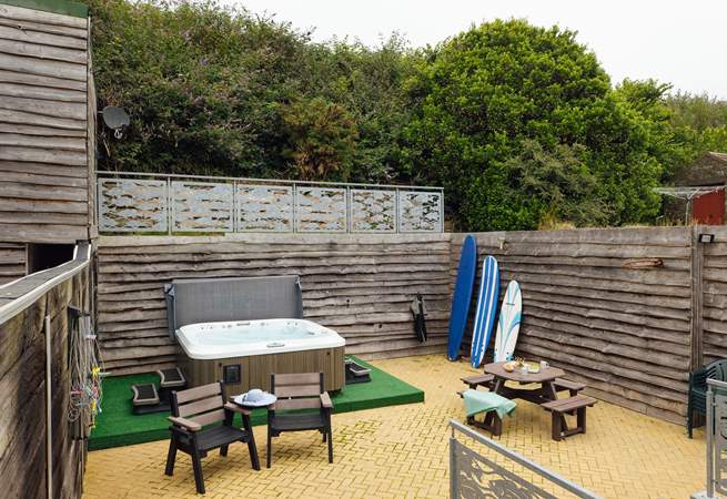 A sunny spot to relax in with luxurious hot tub. Perfect after a beach day. 