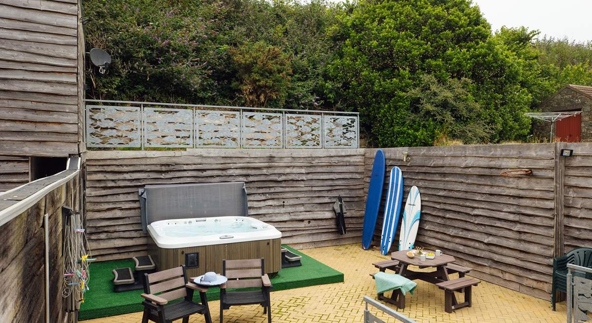 A sunny spot to relax in with luxurious hot tub. Perfect after a beach day. 