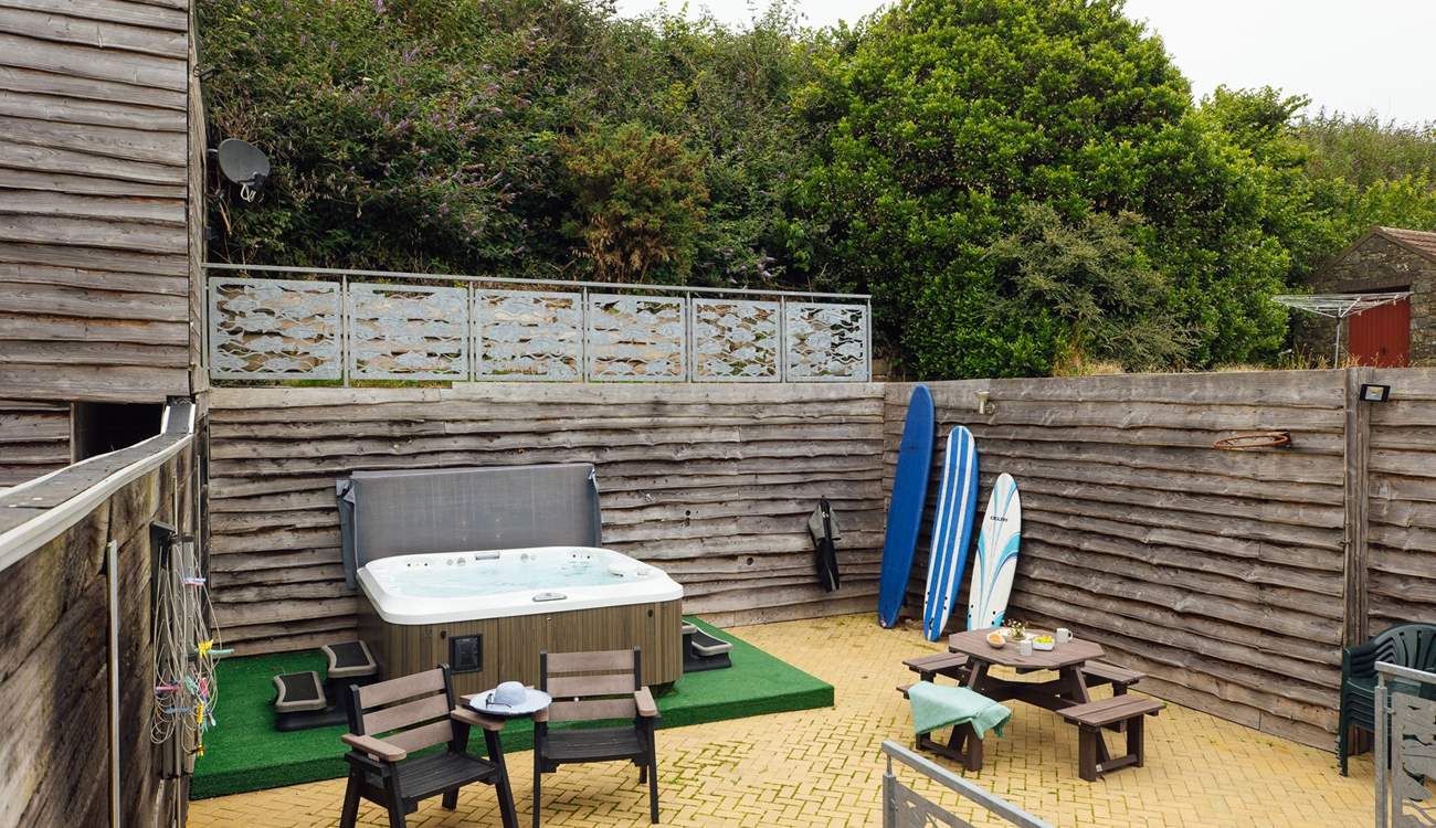 A sunny spot to relax in with luxurious hot tub. Perfect after a beach day. 