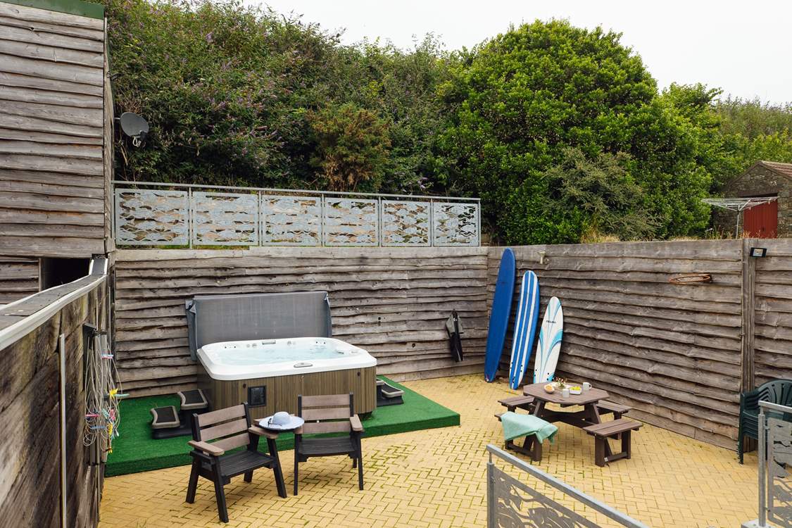 A sunny spot to relax in with luxurious hot tub. Perfect after a beach day.