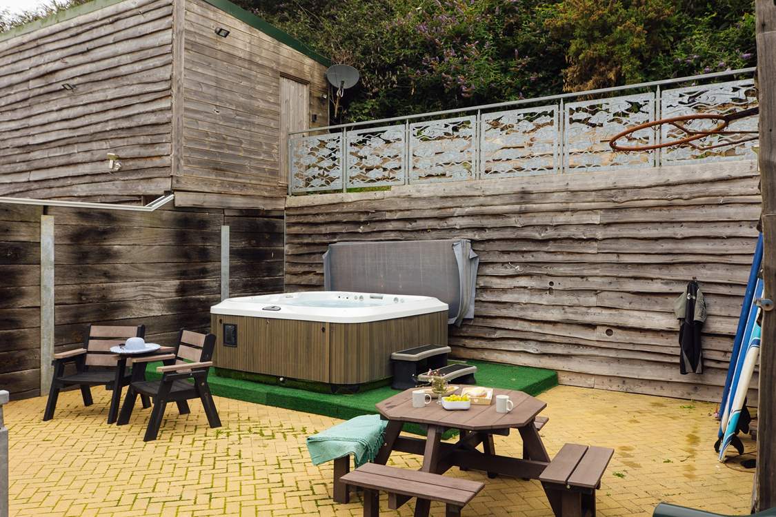 Relax in the luxurious hot tub after a day exploring the magnificent coast.