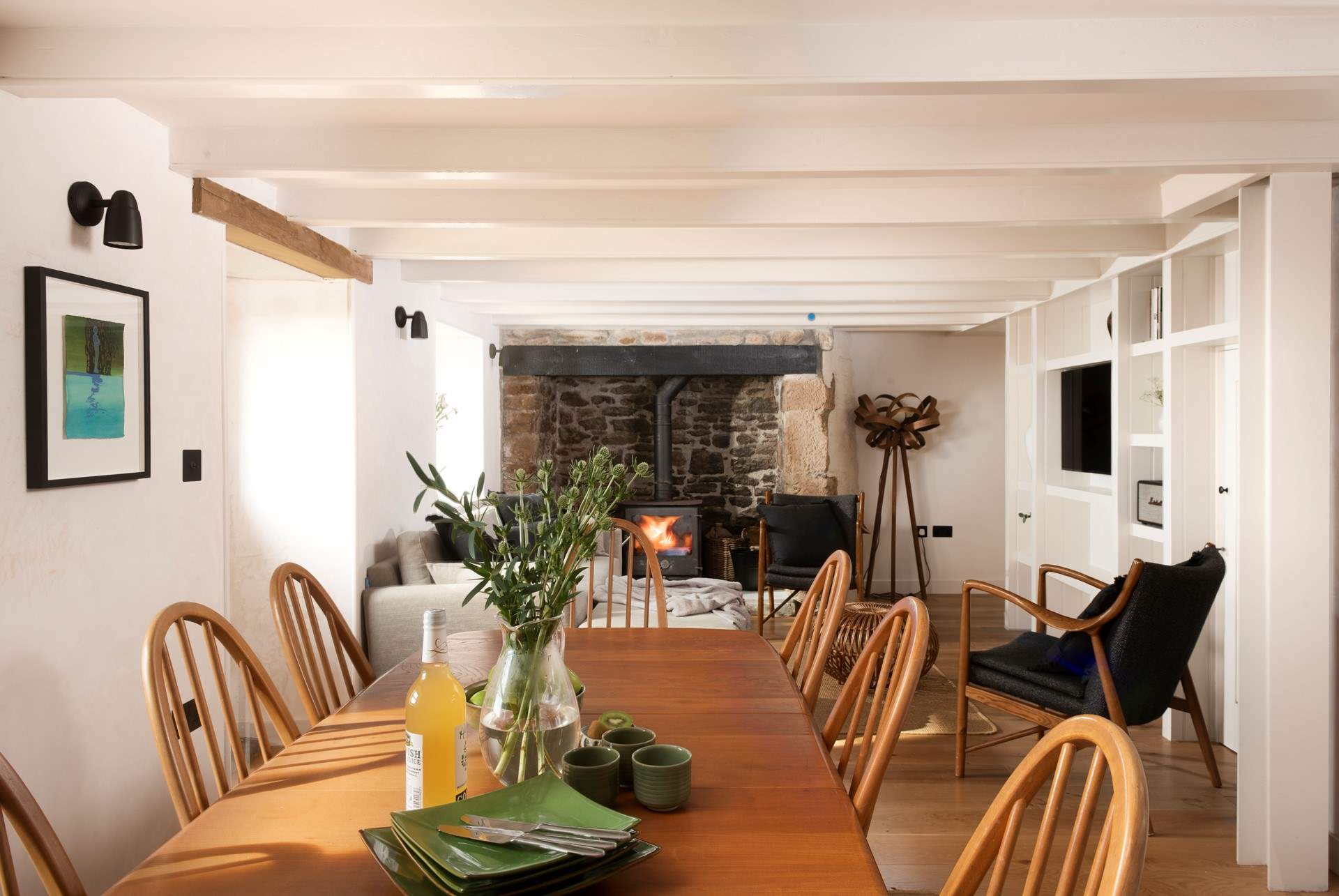 The sitting/dining area is warmed by the wood-burner.