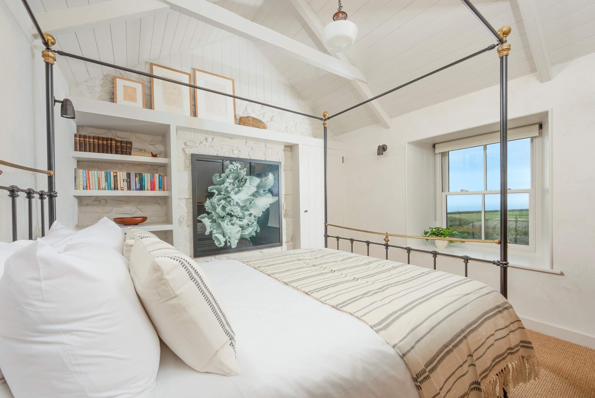 Bedroom 2 boasts this characterful four-poster bed and looks out through the sash windows.