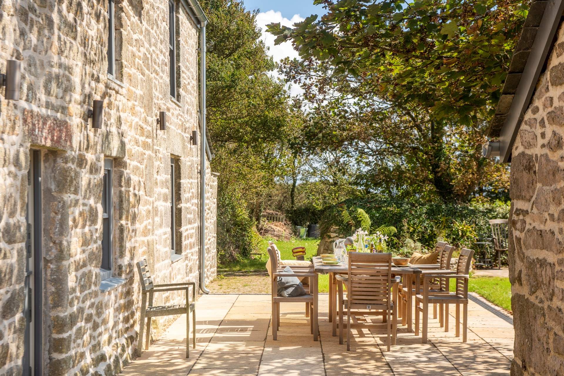 The patio is shaded under the canopy, yet has a sunny disposition.