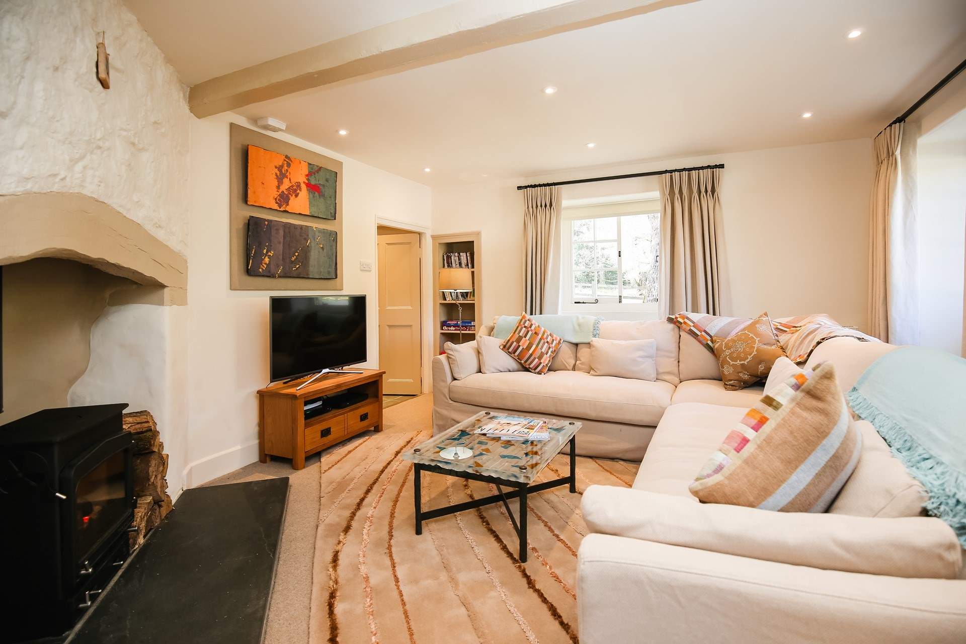 The sitting-room is comfy and cosy, complemented by a glorious wood-burner.