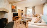 The sitting-room is comfy and cosy, complemented by a glorious wood-burner. - Thumbnail Image