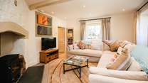 The sitting-room is comfy and cosy, complemented by a glorious wood-burner.