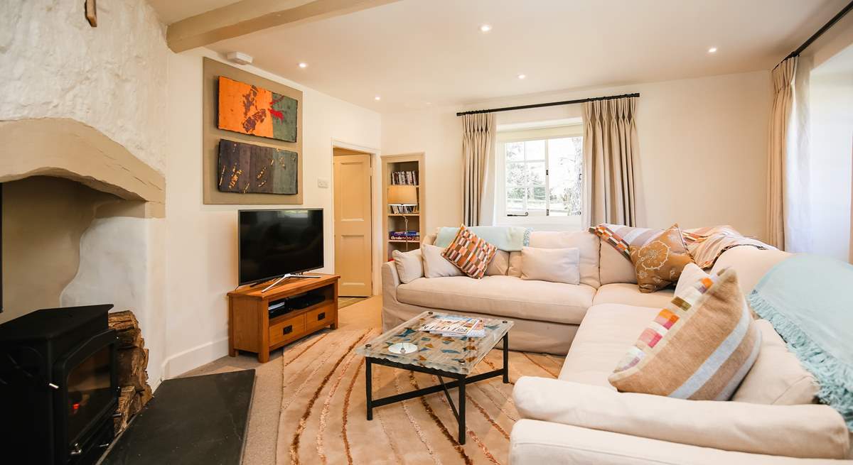 The sitting-room is comfy and cosy, complemented by a glorious wood-burner.