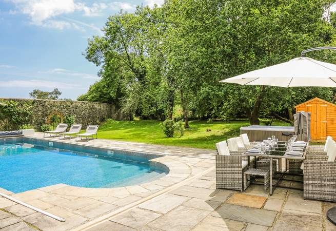 Step out onto the patio-area, where you will be greeted by a bubbling hot tub, glorious heated swimming pool and a fabulous area of lawn for the little ones to let off steam.