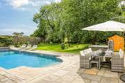 Step out onto the patio-area, where you will be greeted by a bubbling hot tub, glorious heated swimming pool and a fabulous area of lawn for the little ones to let off steam.