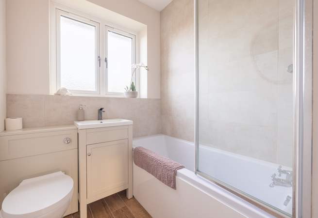 The family bathroom with bath and fitted shower.