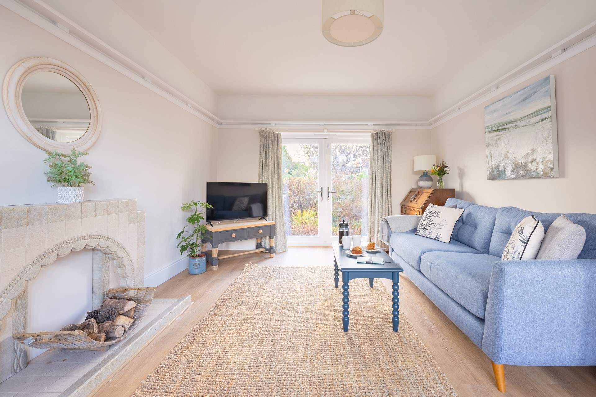 Double doors open from the living area to a small patio and garden.