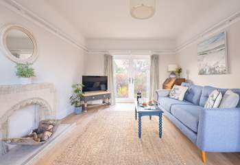 Double doors open from the living area to a small patio and garden.