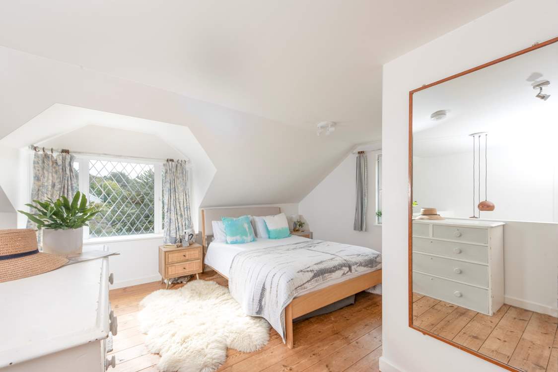 The principal suite is a large and light space.