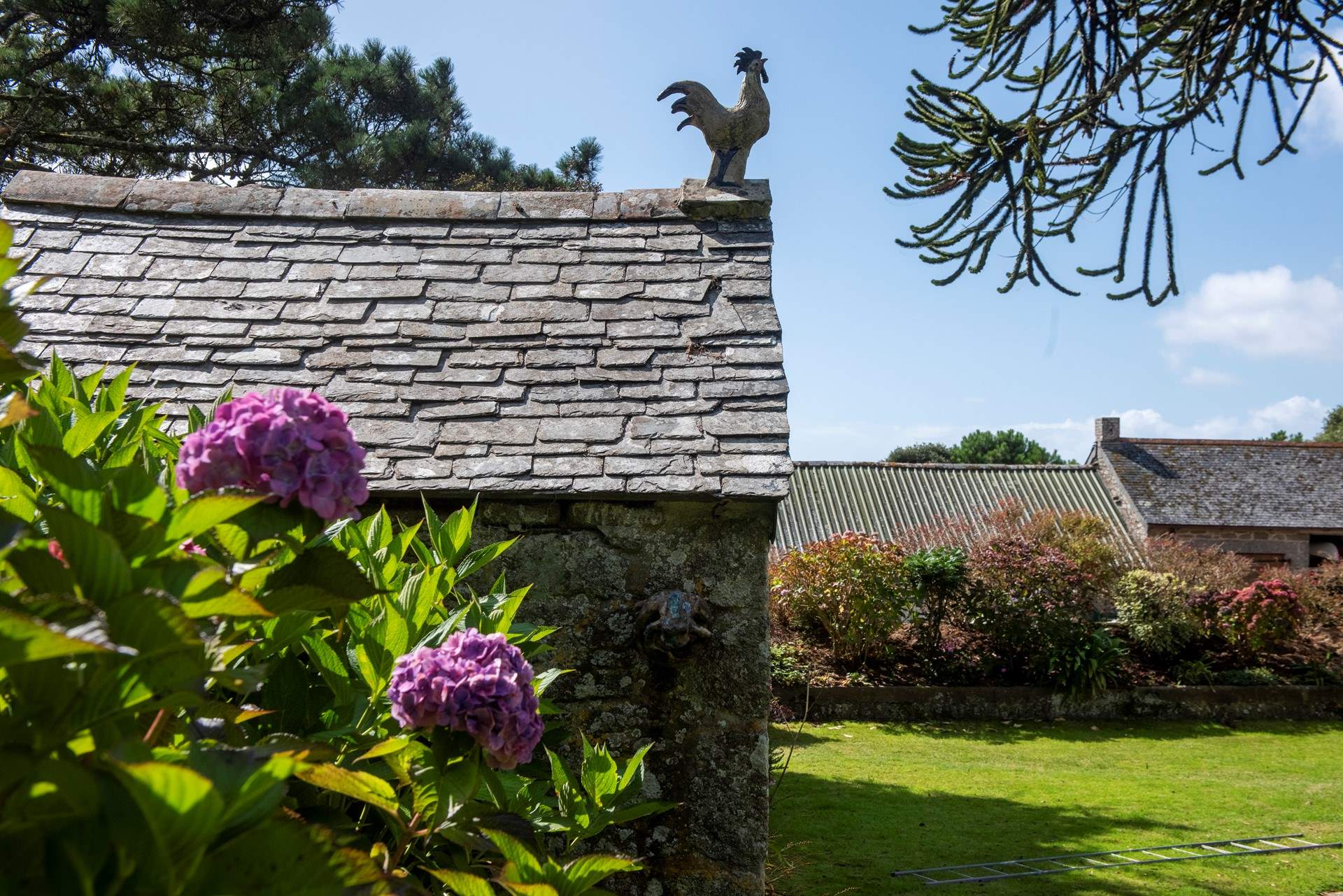 A ceramic cockerel standing proud overlooking the property, crafted by the very creative owners.