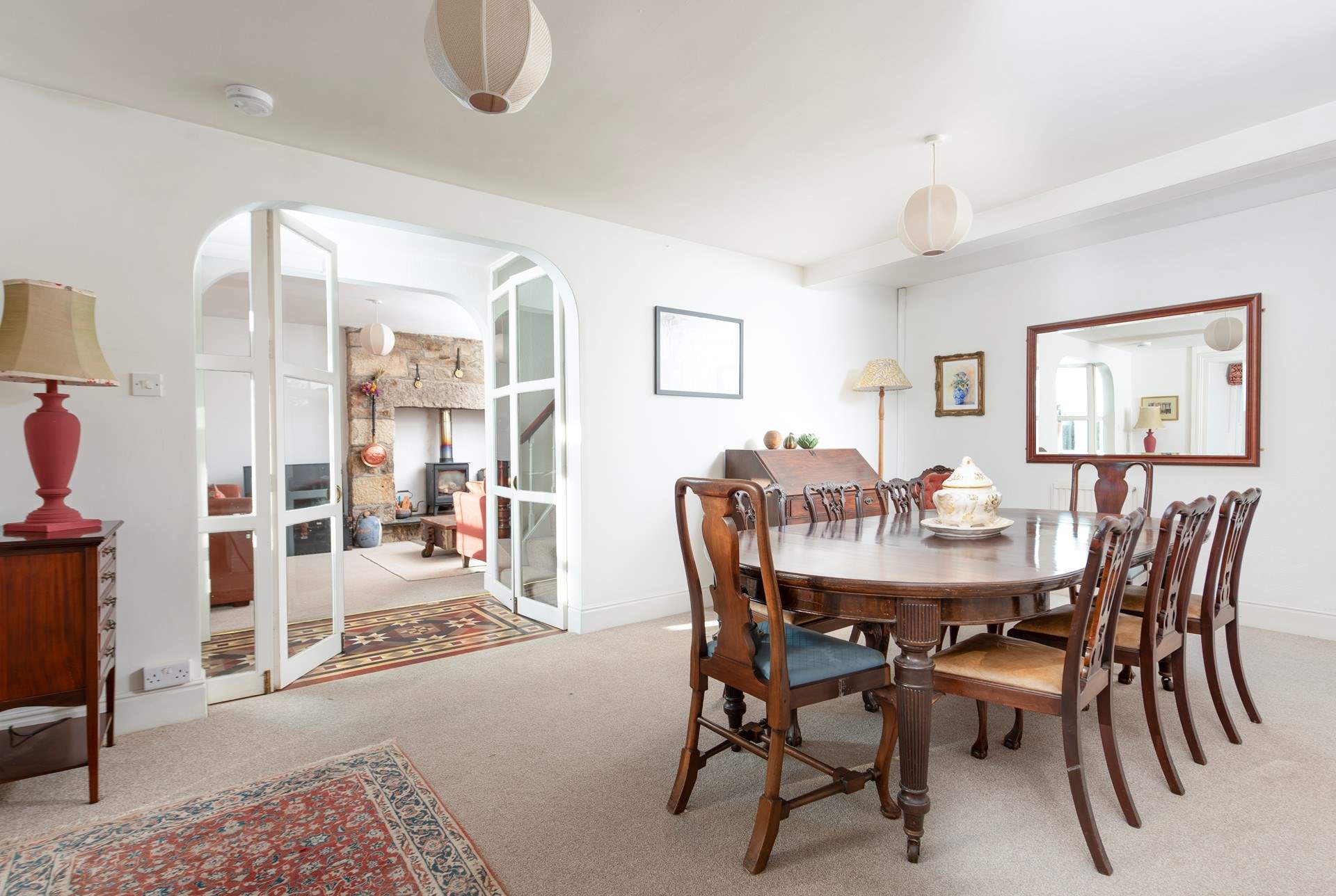The cosy sitting-room leads to the elegant dining-room.