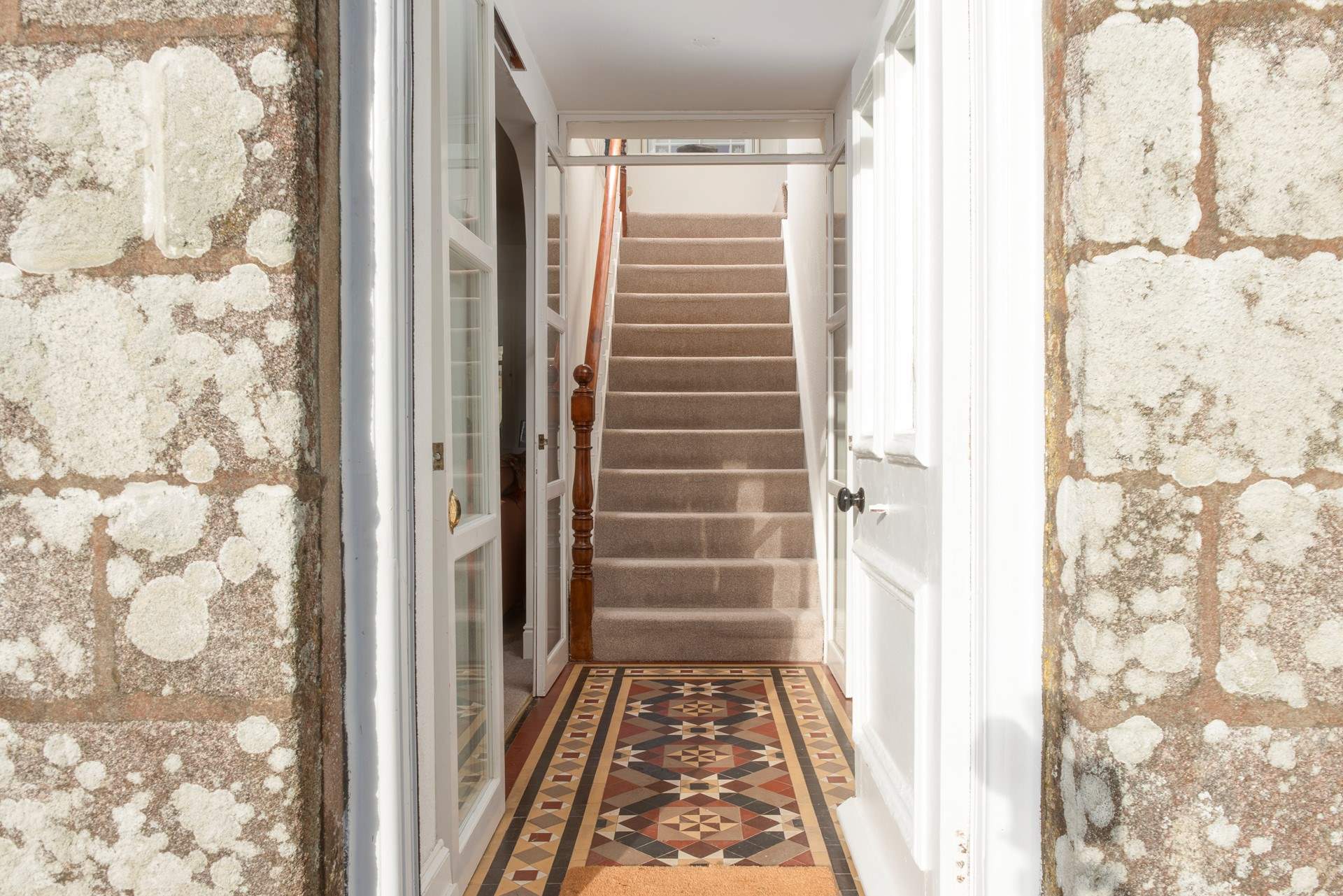 Step inside to the grand yet homely entrance hall where the beautiful geometric tiles lead you to the first staircase.