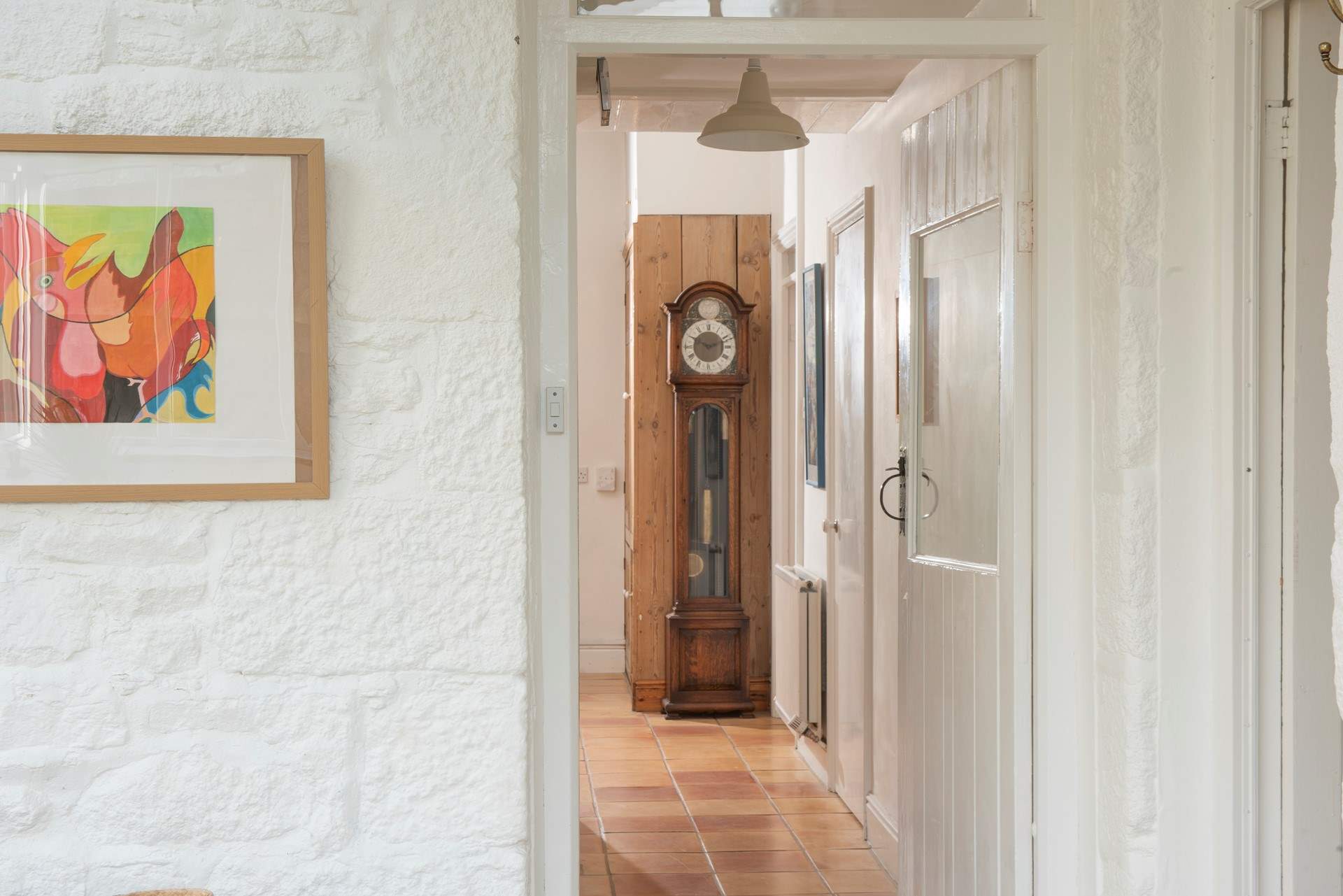 Hand-picked antiques like this striking grandfather clock make this farmhouse feel truly lived in.