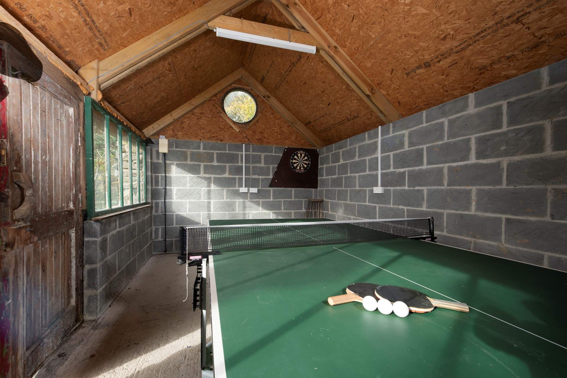 The games-barn in the grounds with table-tennis and darts.