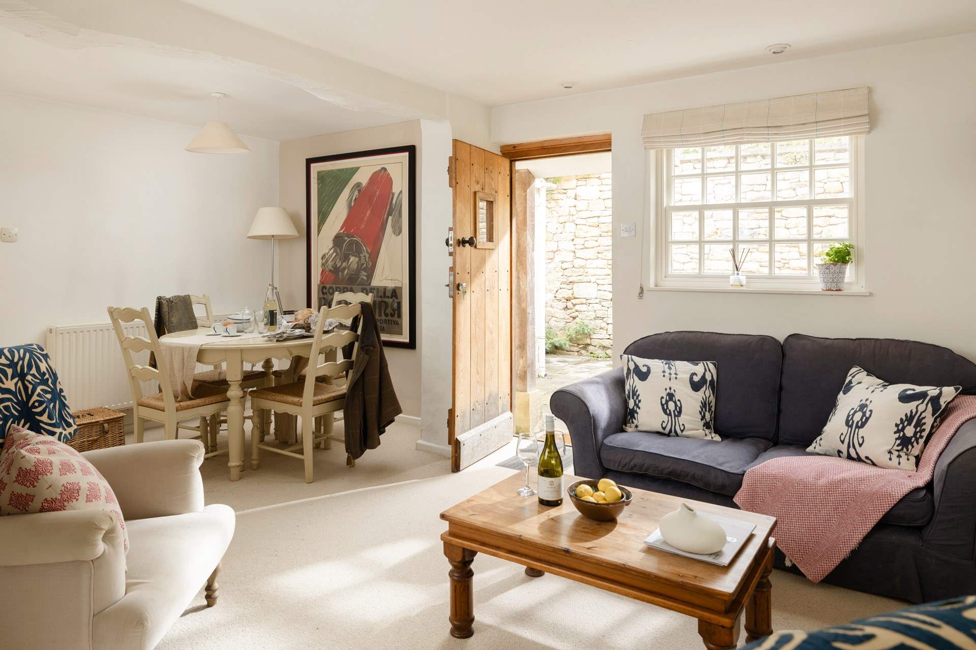The open plan living-room is cosy and stylish and leads to the courtyard.