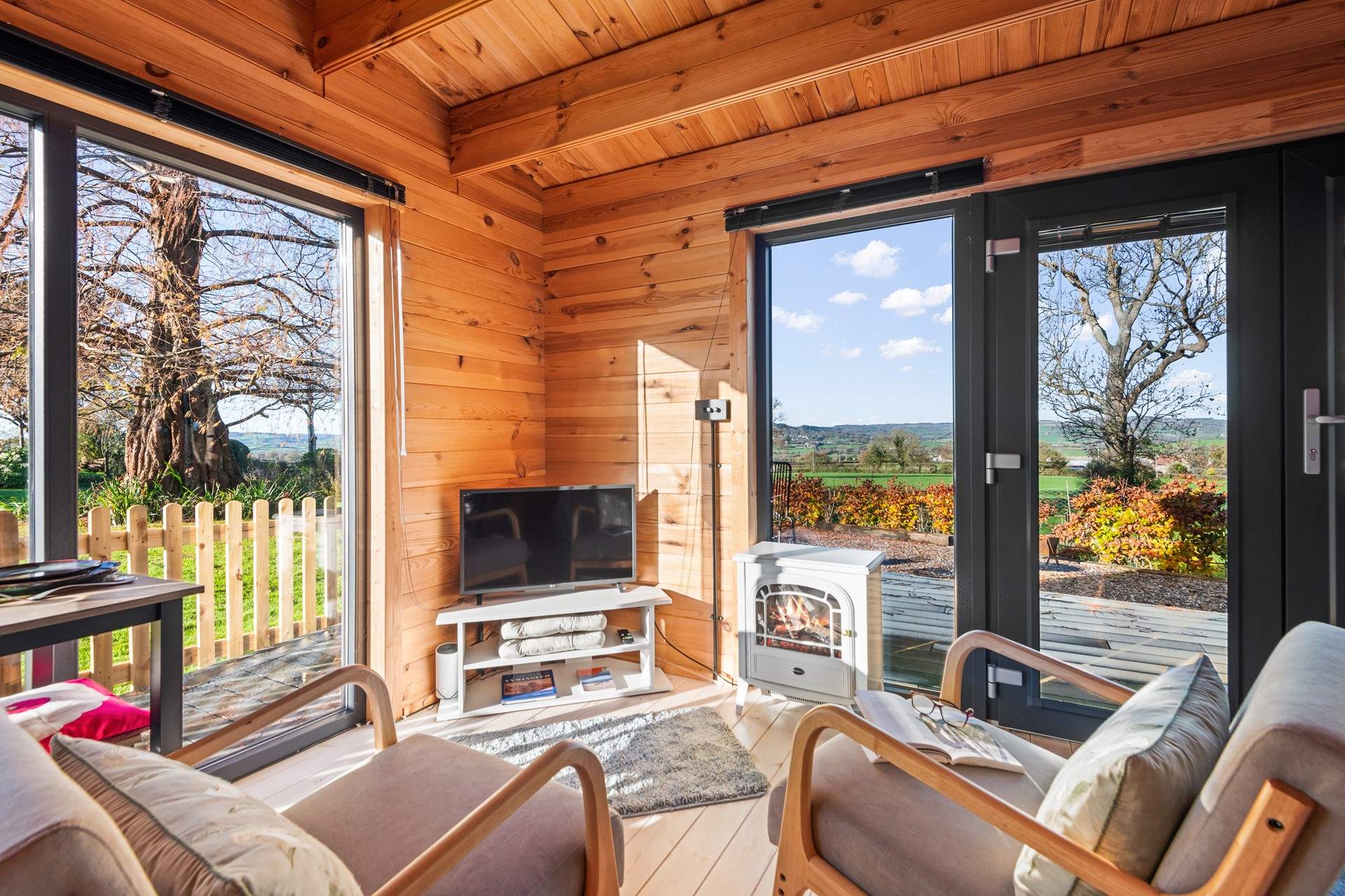 The TV viewing area is equipped with a wood-burner effect electric stove. Whether it be watching TV or soaking up those magnificent views, this is the perfect spot to do so.