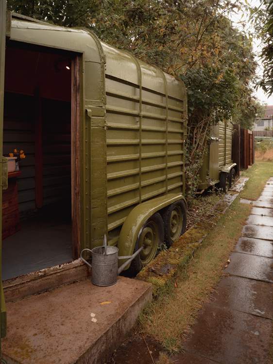 A private outdoor restroom sits to the rear of the tipi.