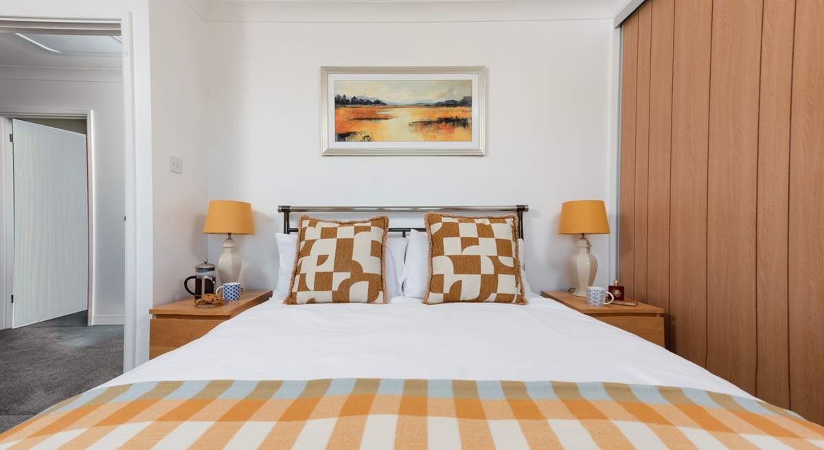 Relax in inviting king-size bedroom 1, designed for comfort and a restful night's sleep.