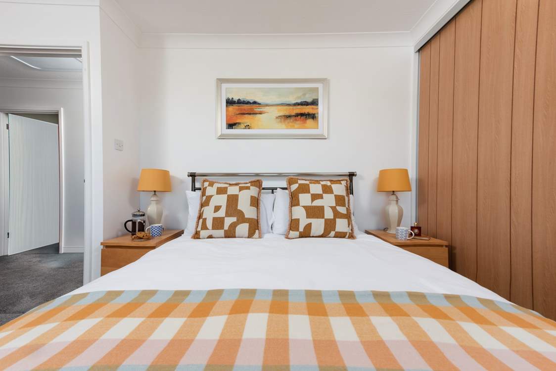 Relax in the inviting king-size bedroom 1, designed for comfort and a restful night's sleep.