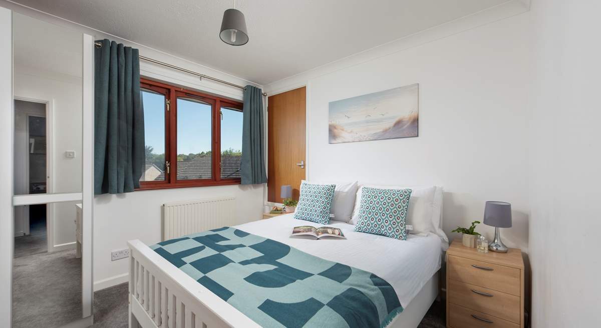 Bright and airy, this bedroom is the perfect place to unwind.