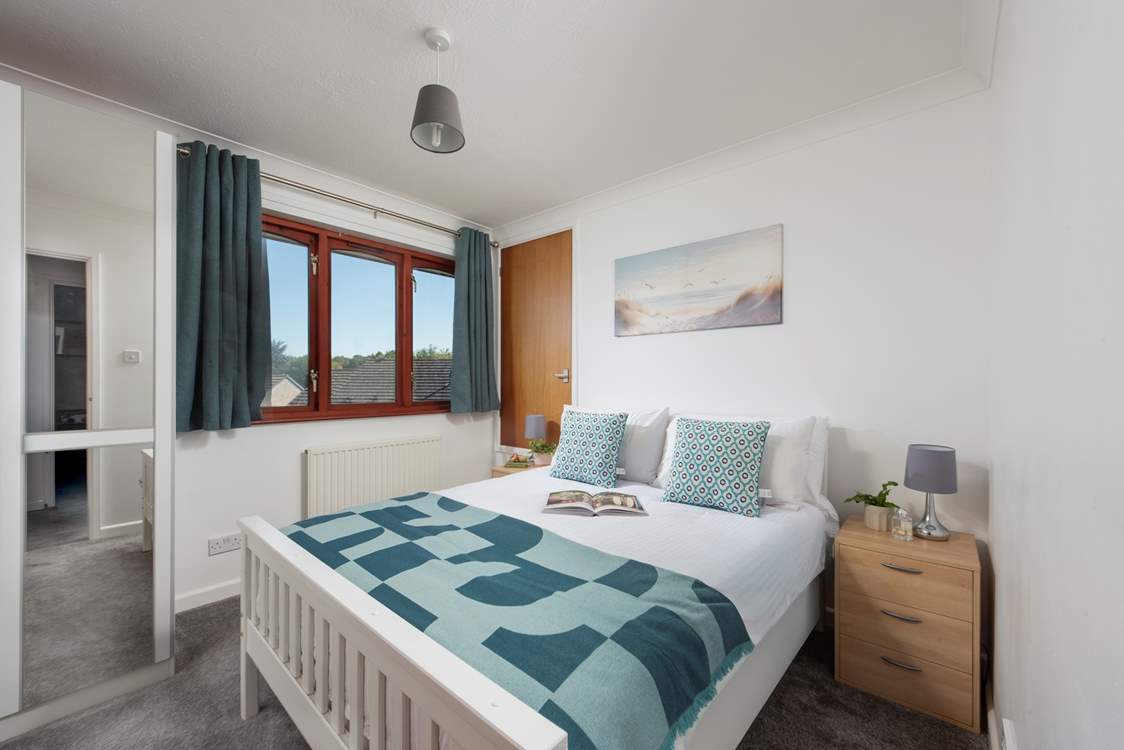 Bright and airy, this bedroom is the perfect place to unwind.