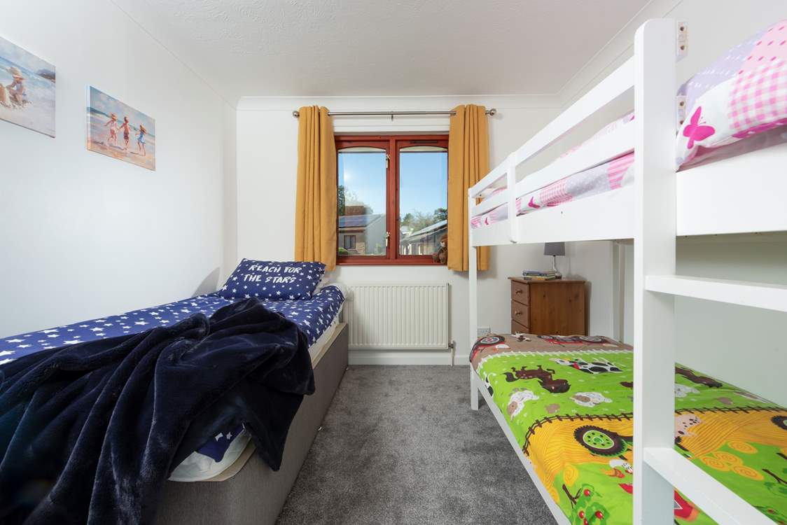 Bedroom 3 welcomes three guests in the bunk-beds and a separate single bed.