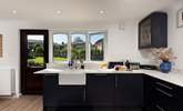 A very modern kitchen and dining area flooded with light and overlooking the garden. - Thumbnail Image