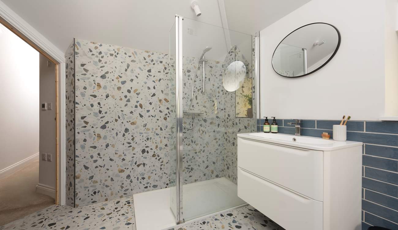 The gorgeous family bathroom boasts a large shower...