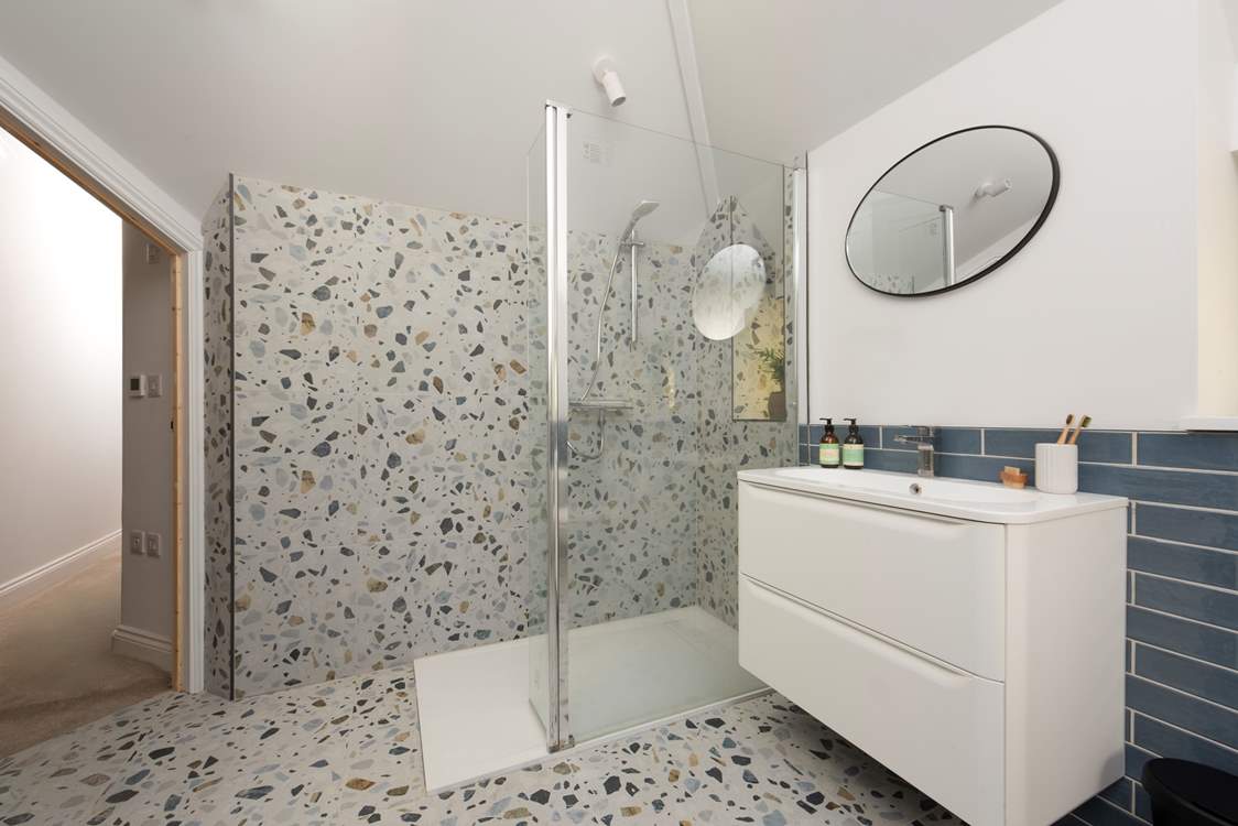 The gorgeous family bathroom boasts a large shower...
