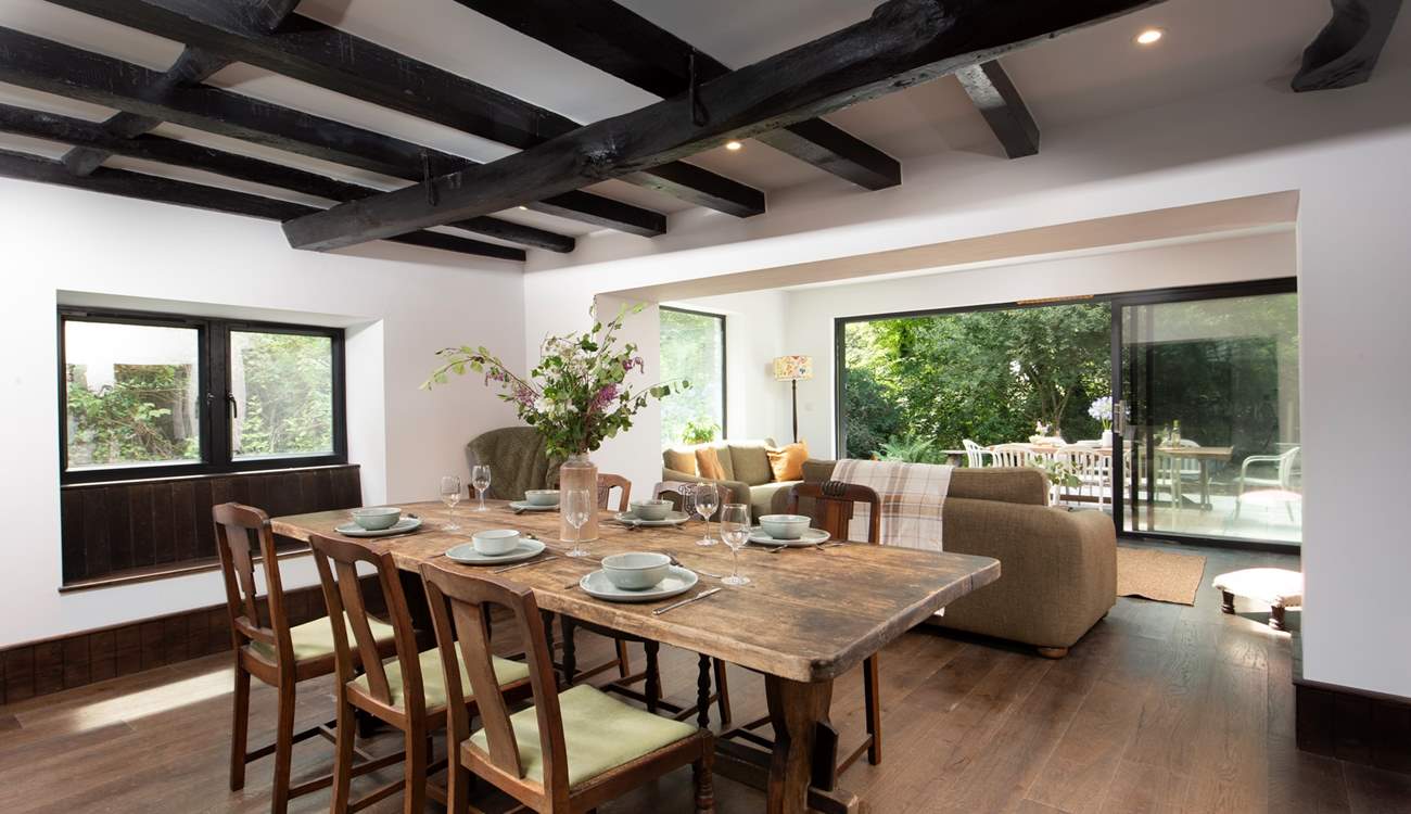 The open plan sitting/dining-room offers oodles of space with a sitting-area looking out onto the terrace, a further seating area around the toasty wood-burner and dining space for all.