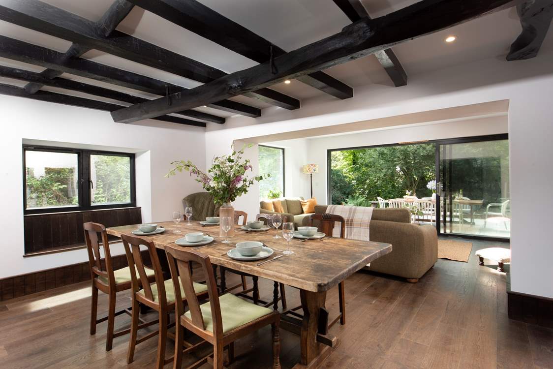 The open plan sitting/dining-room offers oodles of space with a sitting-area looking out onto the terrace, a further seating area around the toasty wood-burner and dining space for all.