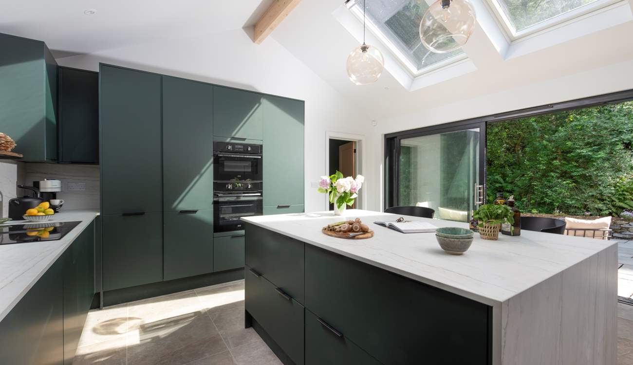 Gather around the island in the stylish kitchen.