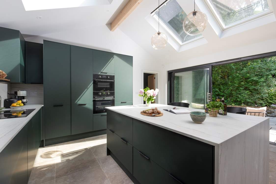 Gather around the island in the stylish kitchen.