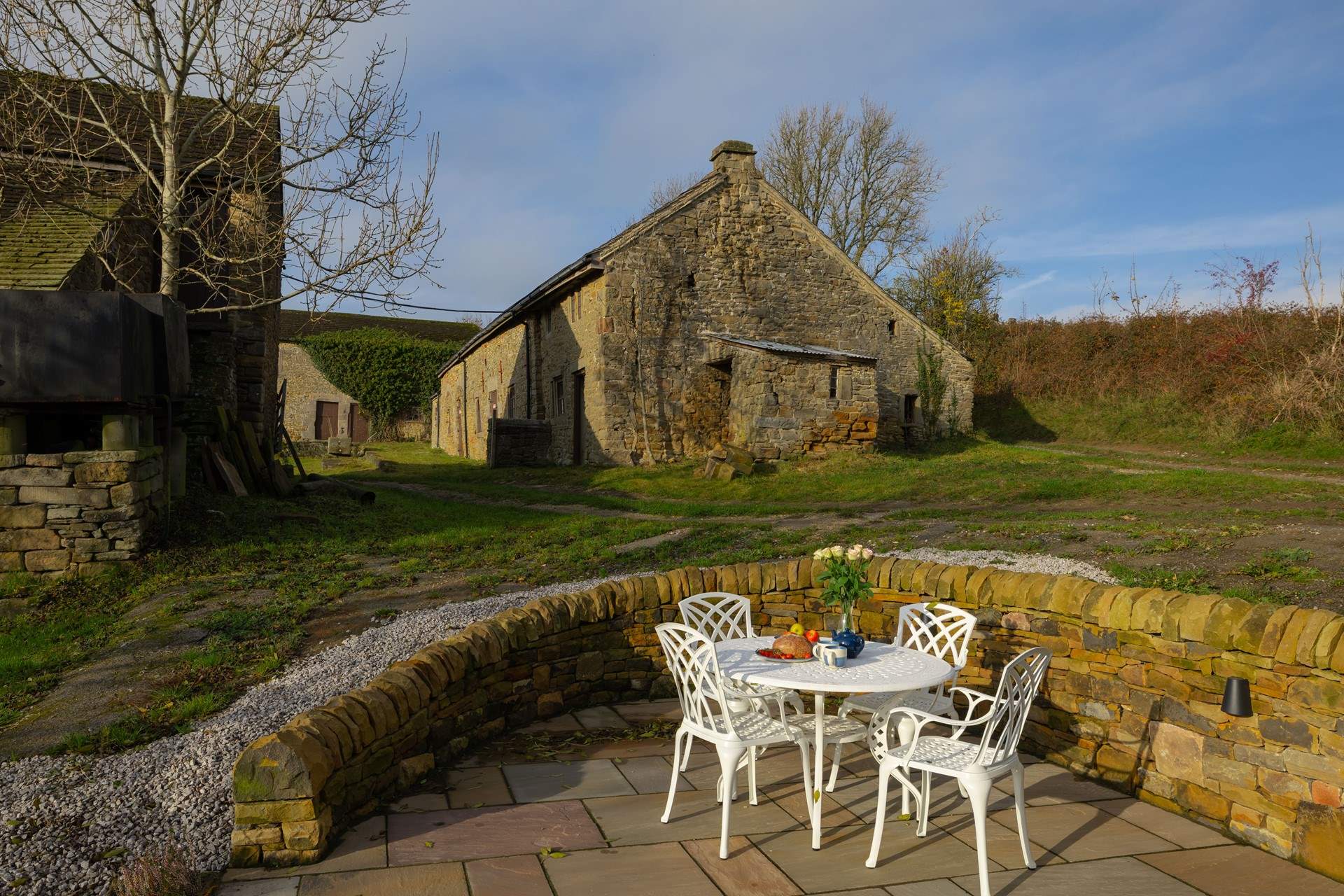Old, unused farm buildings frame the adjacent farmyard. Please ensure children are supervised at all times when using the patio space.