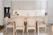 Lots of space for dining and socialising at this lovely dining-table. The kitchen is fully stocked with Neff appliances, including a large fridge/freezer, dishwasher, microwave and coffee machine.