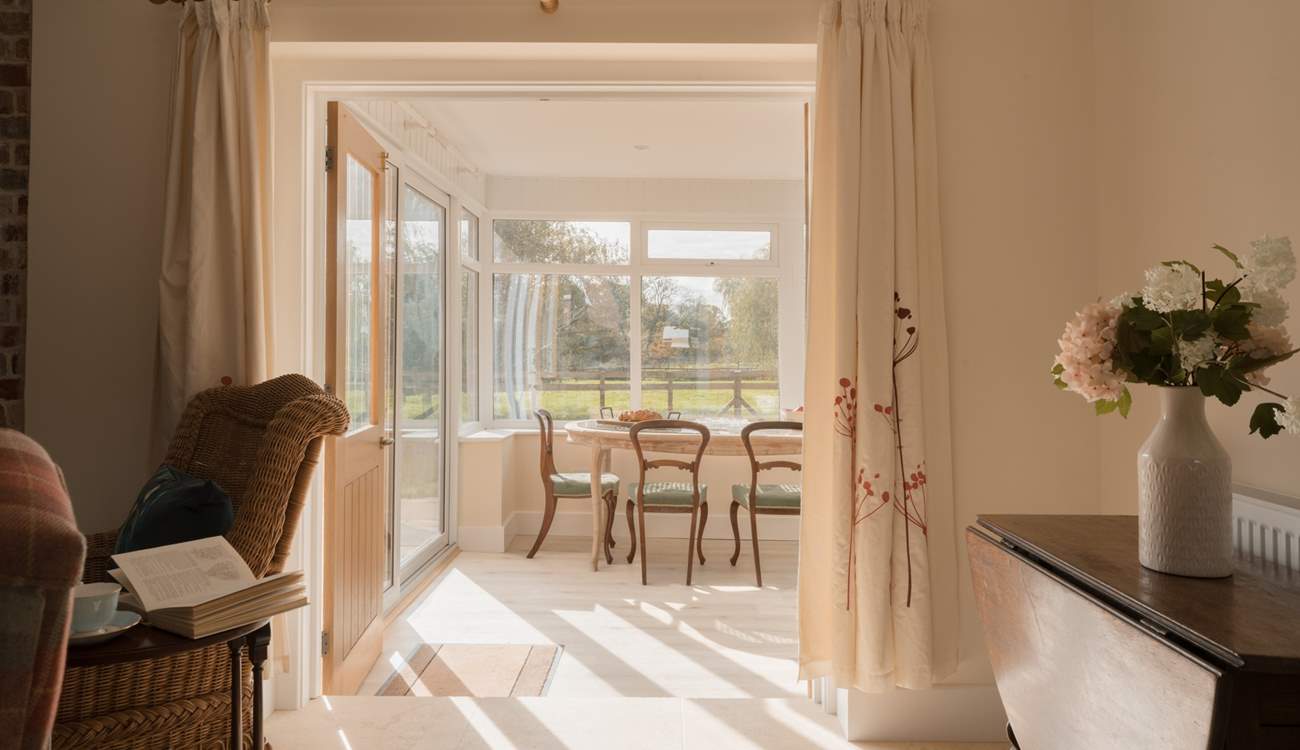 Leading off the lounge is a large conservatory space with expansive views over the garden and fields beyond... Note that there is a small step down into the conservatory.